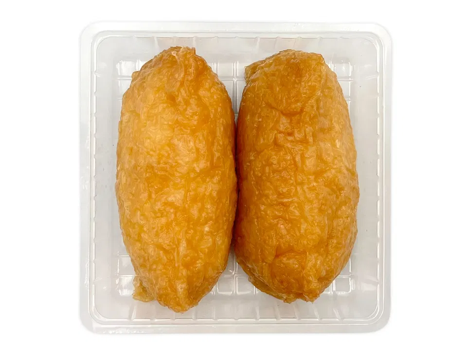 Two pieces of dashi-infused inari sushi